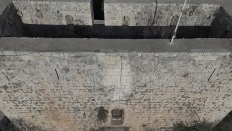 drone view among the buildings, stone castle in the city center, belenkeşlik castle