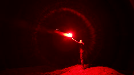 the man with a bright firework stick standing outdoor