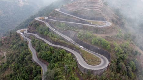 an aerial view of traffic on the bp highway, bardibas highway, showing the switchbacks and turns as it winds through the hills of nepal