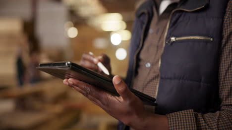 man using a tablet in a warehouse