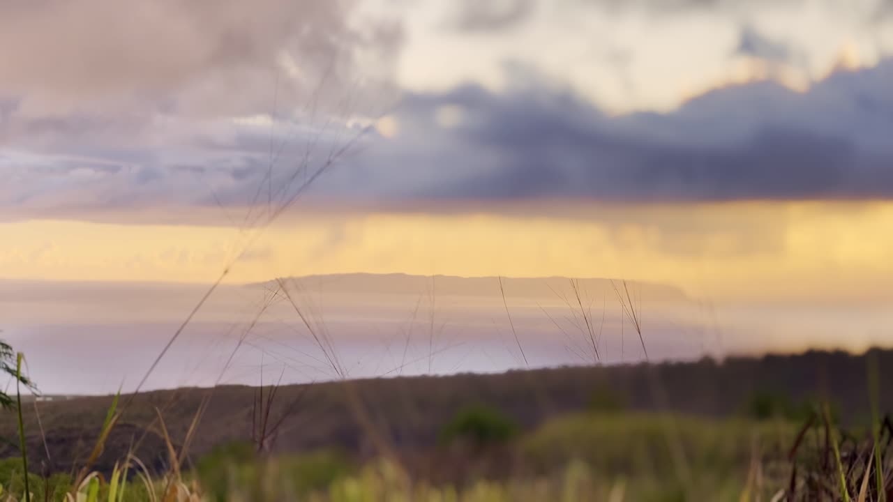 Cinematic long lens shot of Ni'ihau, the Forbidden Island, at sunset off the coast of Kaua'i in Hawai'i