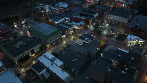 rainy november day in historic town of usa at dusk. aerial birds eye shot. apartment houses and office buildings in america. parking cars on street with lighting streetlamps.