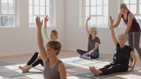 yoga-class-of-healthy-mature-women-exercising-instructor-teaching-group-practice-enjoying-morning-physical-fitness-workout-in-studio