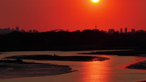 red and orange sunrise above rotterdam city and river noord early morning