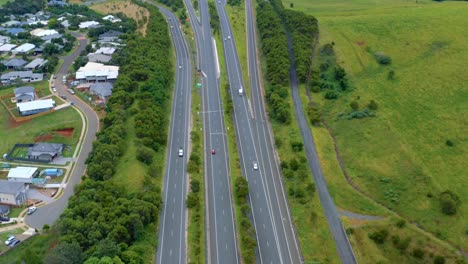 cars driving at carriageways with green fields and mountains in byron bay, australia