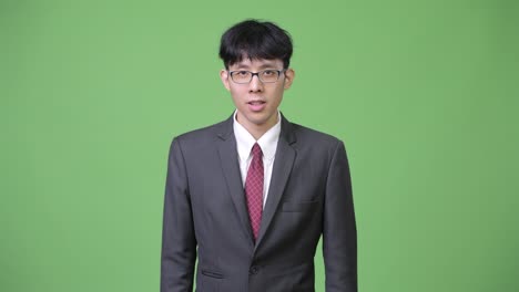 young asian businessman shocked