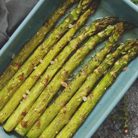 close up with selective focus on roasted asparagus seasoned with salt  pepper  garlic