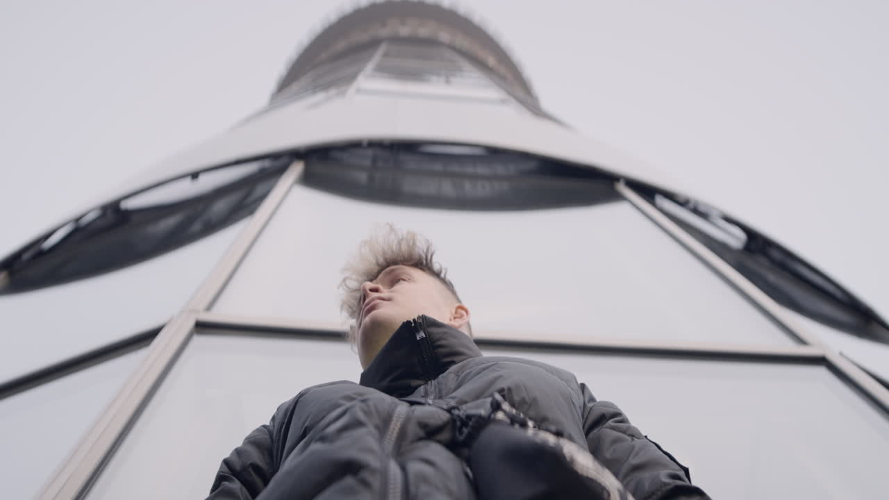 Person standing in front of a modern tower