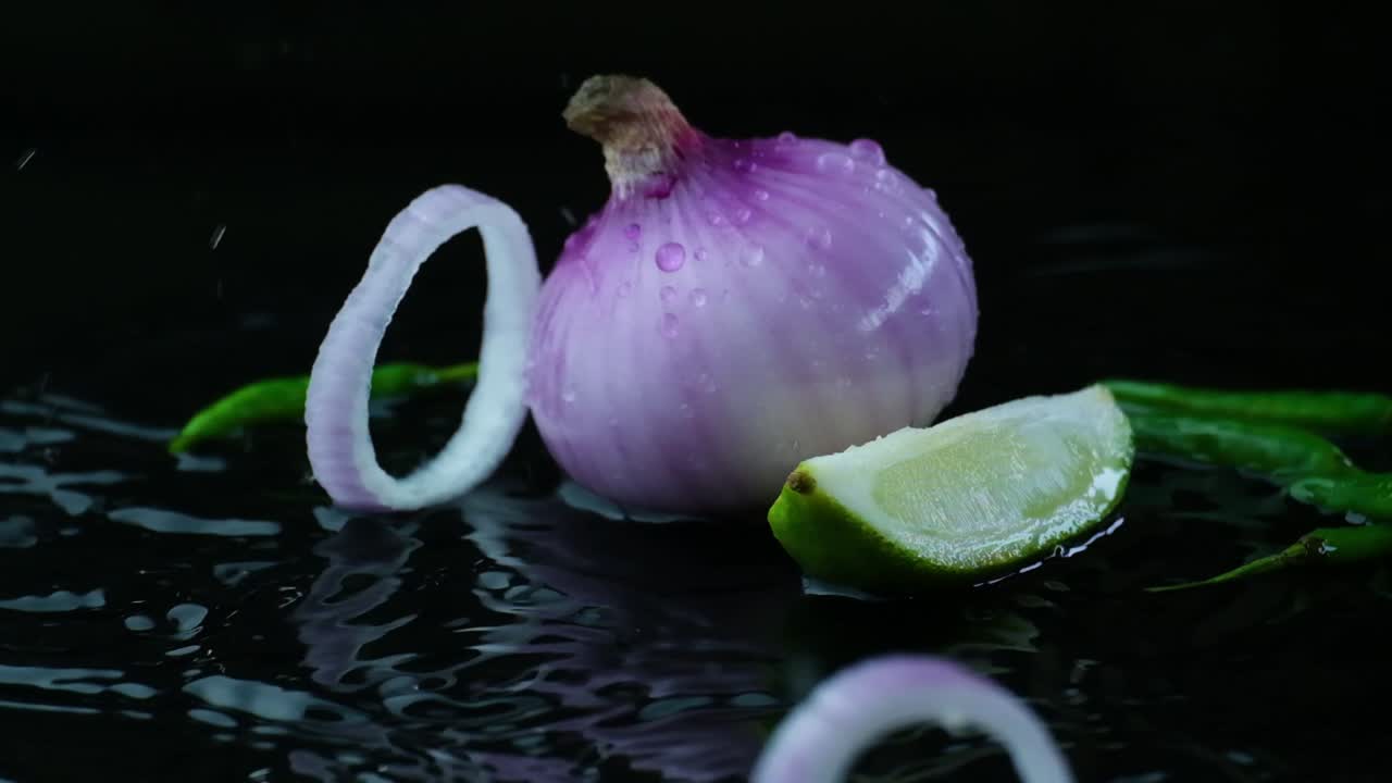 Whole Red Onion And A Slice With Sliced Lime In Puddle Of Water