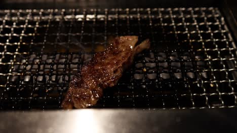 steak being flipped and grilled to perfection