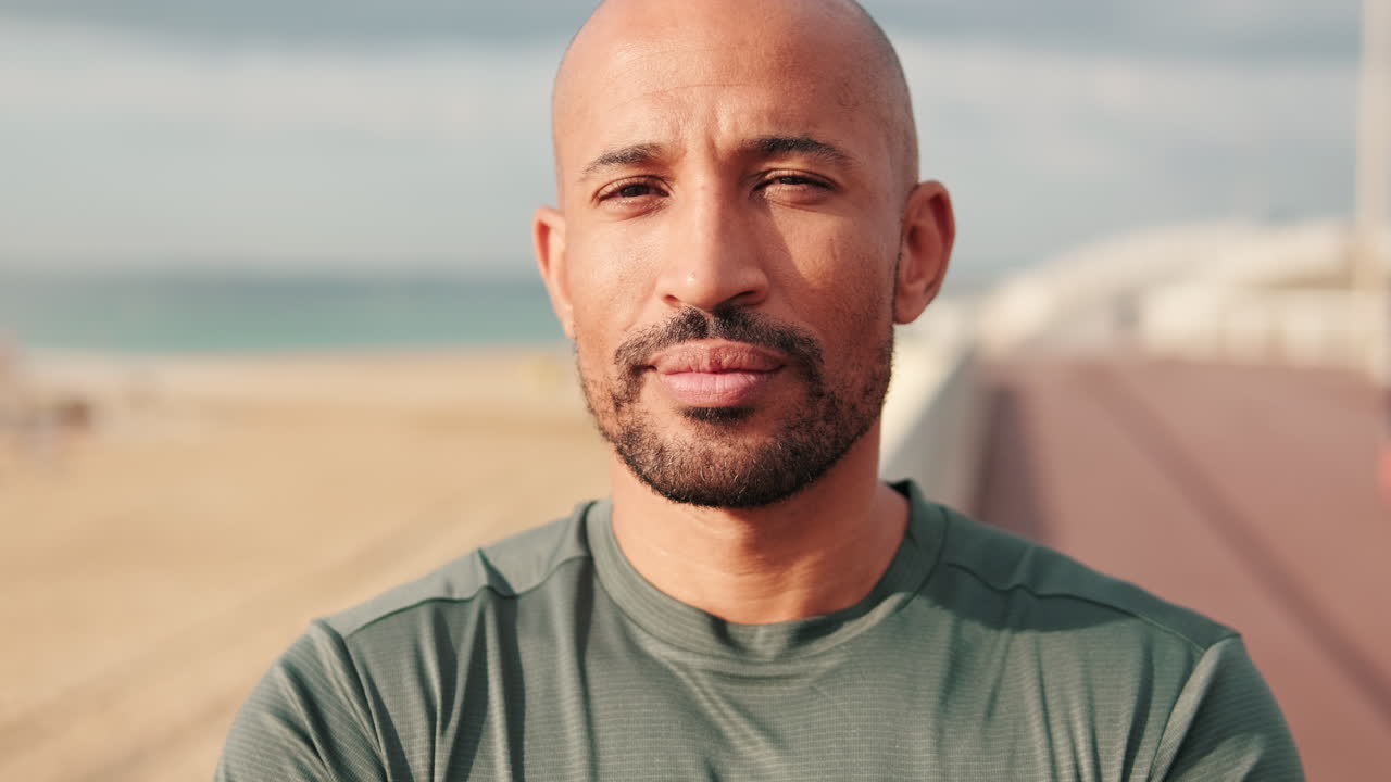 Bald Bearded Man Looking at Camera on Beach Boardwalk