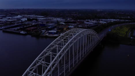 steel arch bridge over noord river in south holland, the netherlands during sunset