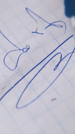 nervous man holds modern blue pen above words just do it on checkered paper sheet extreme close view