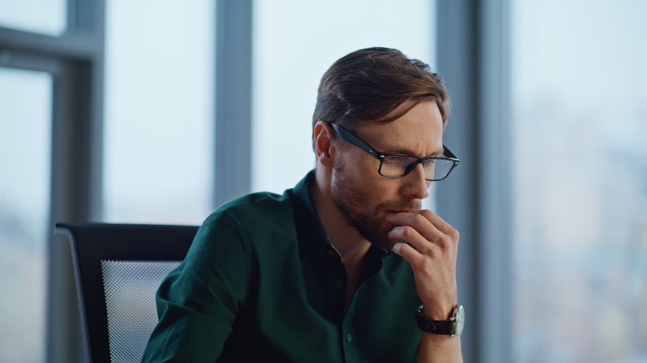 Thoughtful manager creating marketing strategy in light office interior closeup