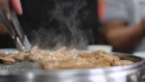 people enjoy grill and eat steaks together