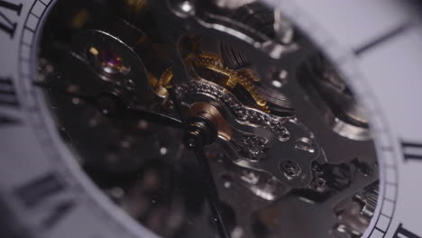 light passes through an old watch mechanism working