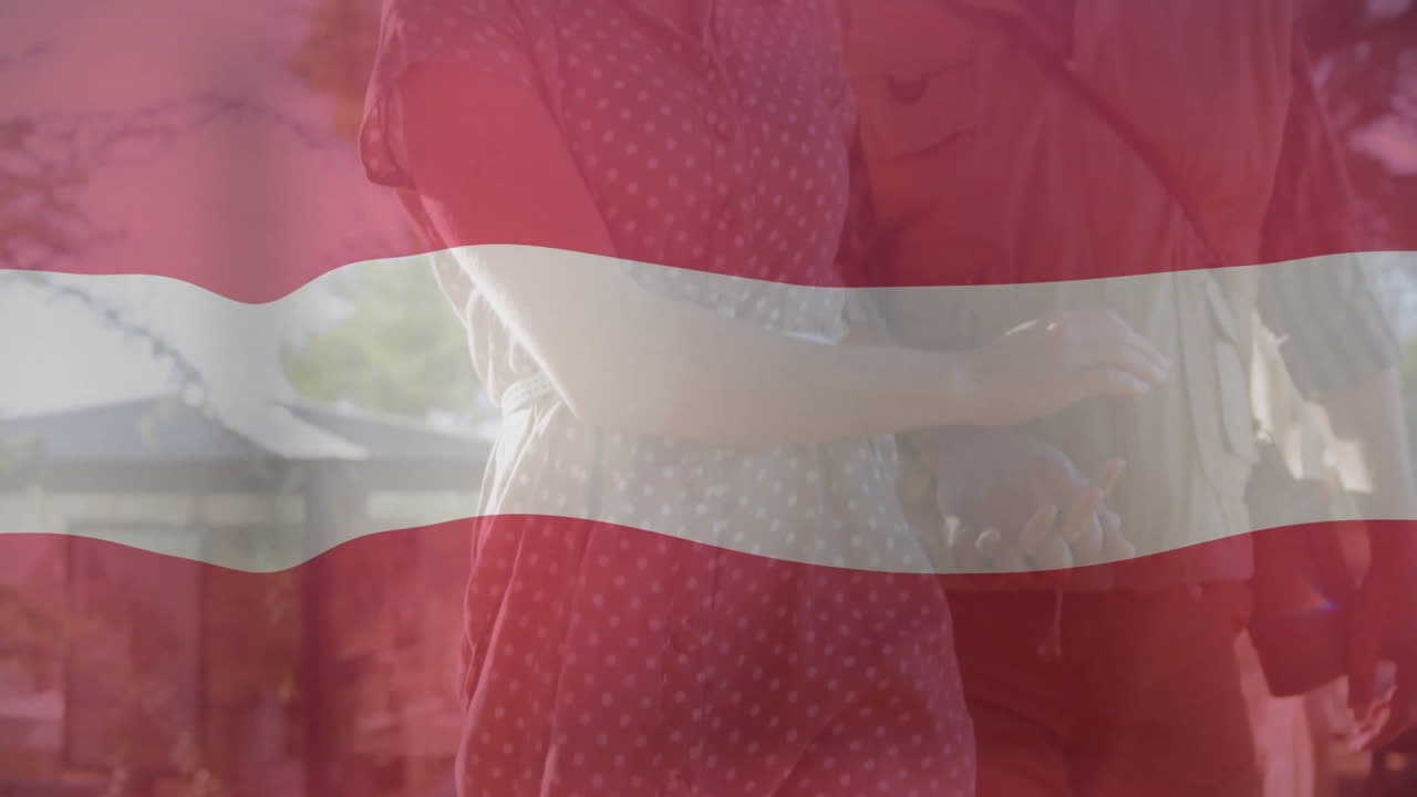 Walking hand in hand, couple with Latvian flag animation in background