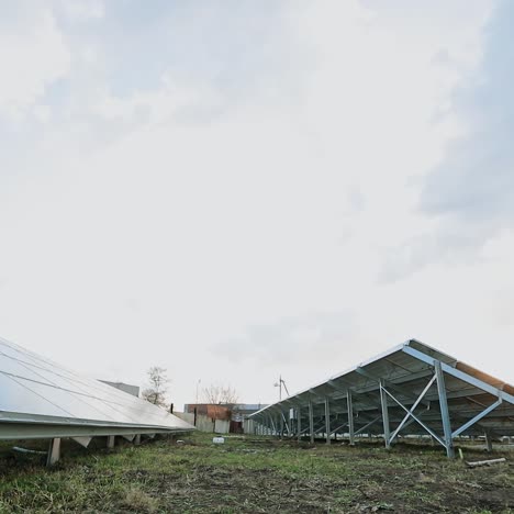 innovative solar farm. metal constructions with sunny batteries on the ground. photovoltaic solar panels produce alternative energy. view from below.