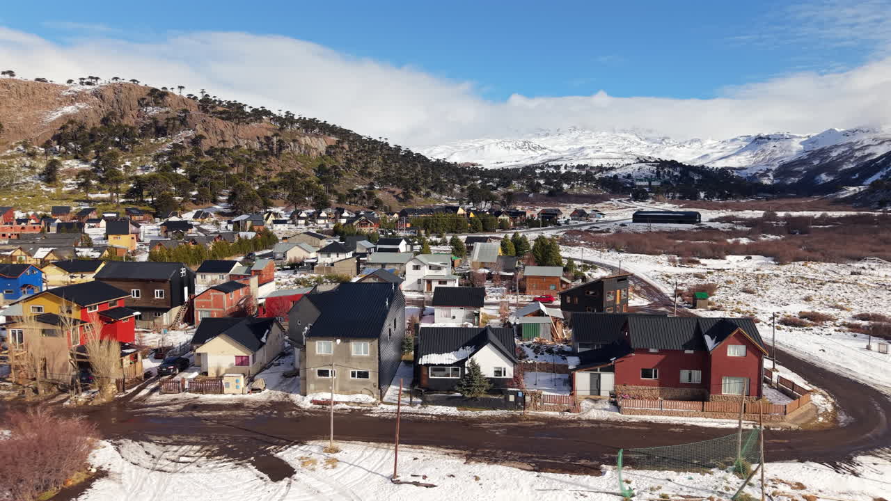 Picturesque snowy town of Caviahue in Neuquen, Argentina, with mountain backdrop, aerial view