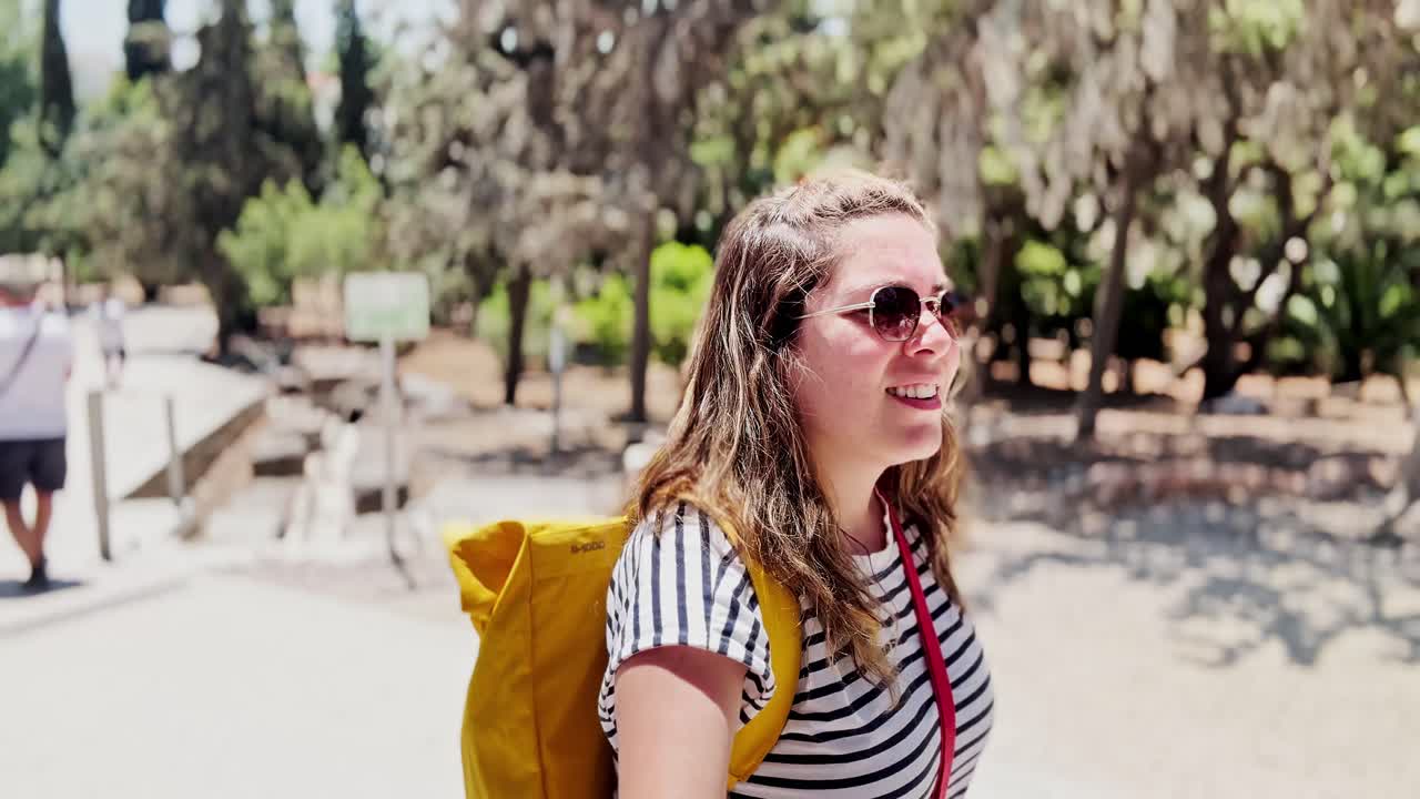 Female Vlogger Talking to Camera at a Historic Site, Athens, Greece