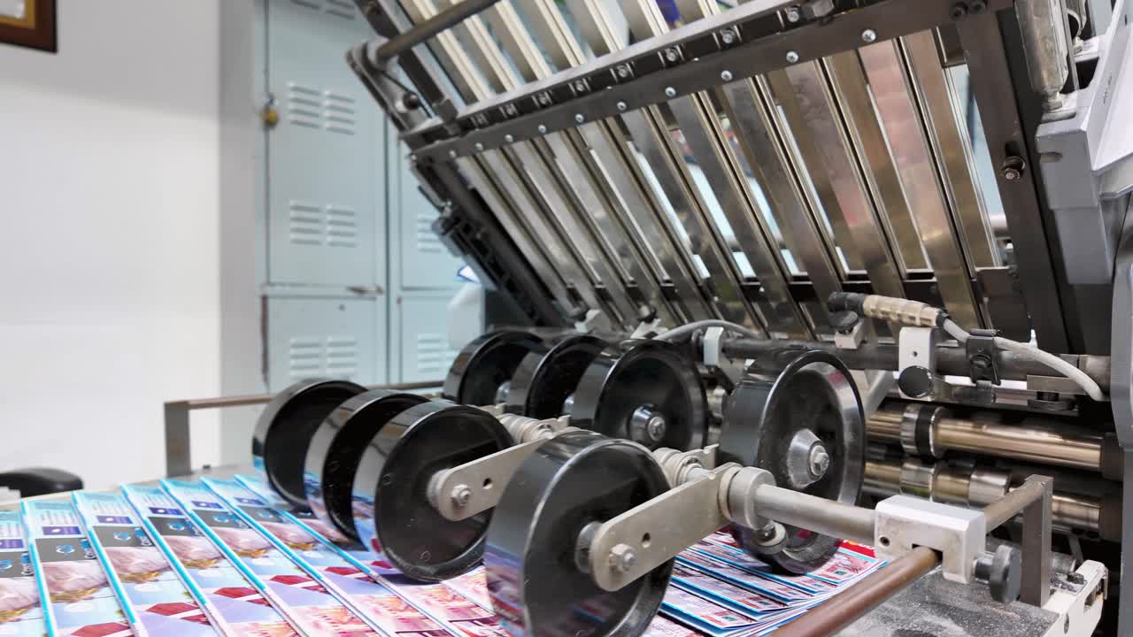 Offset Printing Process. Close up Folding machine. Detail with print products