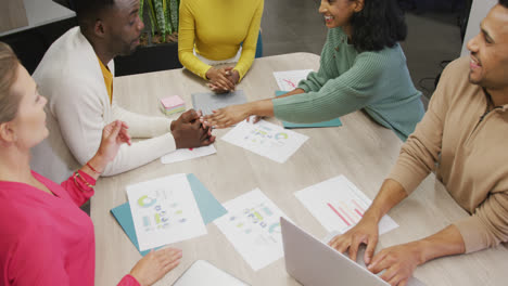 happy diverse male and female business colleagues teaming up in office