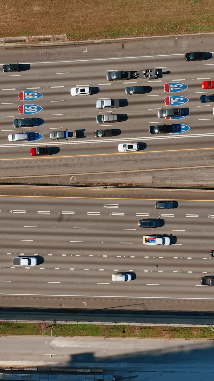Fast intense road traffic with different types of transport. Atlanta Georgia aerial top down view, Interstate 85 highway. Vertical video