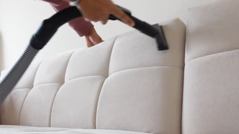 woman vacuuming a couch