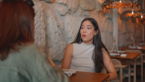 two women having conversation in restaurant