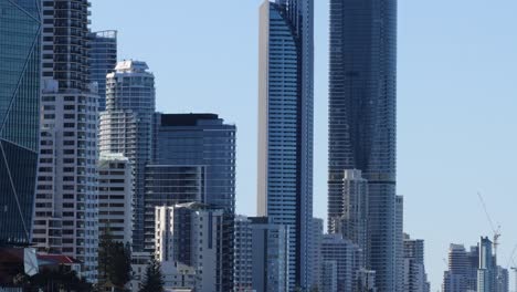 a view of towering skyscrapers against a clear blue sky in a bustling urban area.
