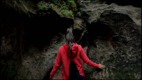 Young-explorer-walks-through-a-narrow-path-in-caves-and-caverns-in-Estrecho-de-la-Arboleja-or-Agualeja-in-Murcia,-Spain