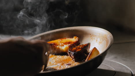 sautéing sweet potatoes in a sweet brown sauce in slow motion