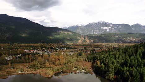 Mountainous-Community-in-Forested-Valley,-Snowy-Peaks-Next-to-a-Lake,-Colourful-Hillside-with-Houses,-Pemberton-British-Columbia,-Canada