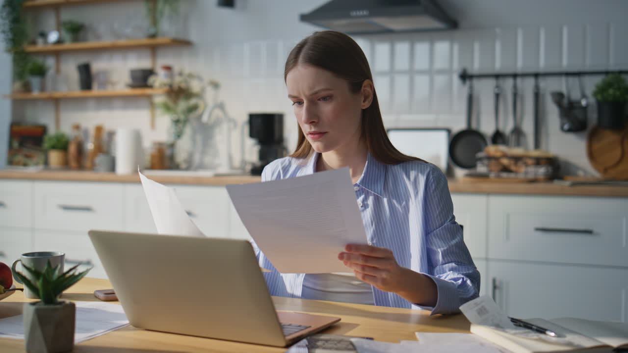 Busy woman dissatisfied paperwork working laptop in modern home office closeup