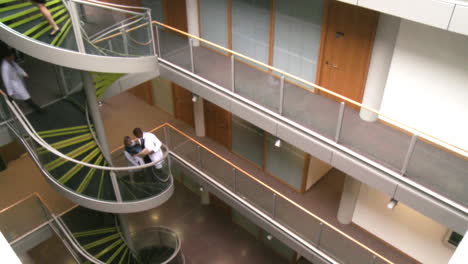 high angle of doctors going upstairs in a hospital