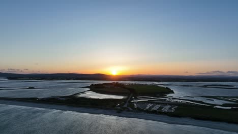 Maguelone-cathedral-island-and-lagoon-in-France-during-sunset,-Aerial-dolly-left-shot