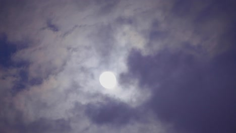 some clouds moving in front of moon