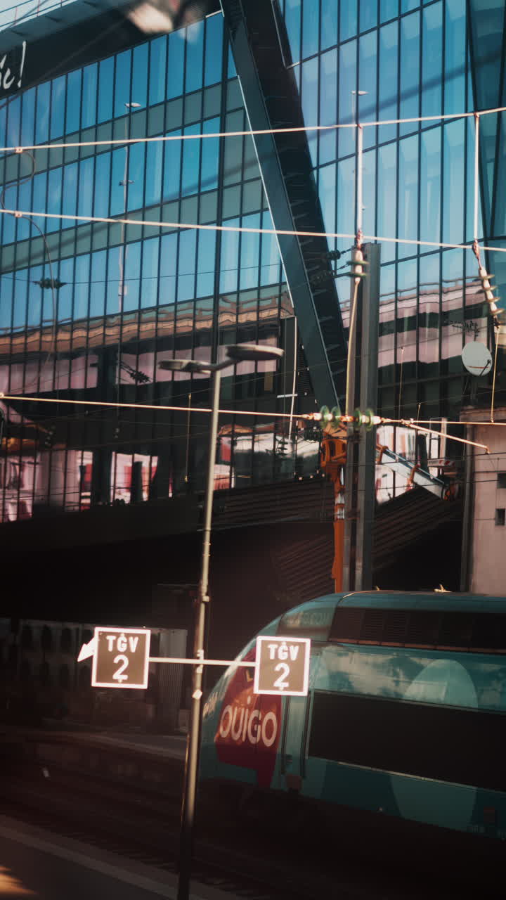 View from a moving train of the exit of the Cannes train station in France. Vertical