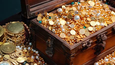 a wooden chest filled with lots of gold and pearls