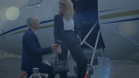 network of connections against caucasian businessman and businesswoman discussing at the airport