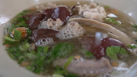 close-up footage of pig blood pudding and pork insides soup, thai popular breakfast selling in both restaurant and street market