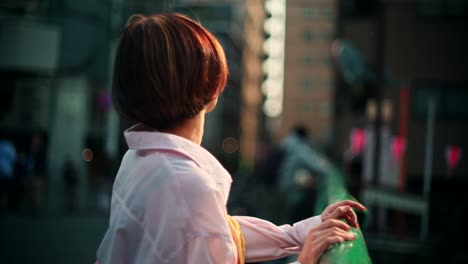 woman in pink shirt on bridge in japan