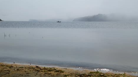a fisherman in a boat on lake baikal