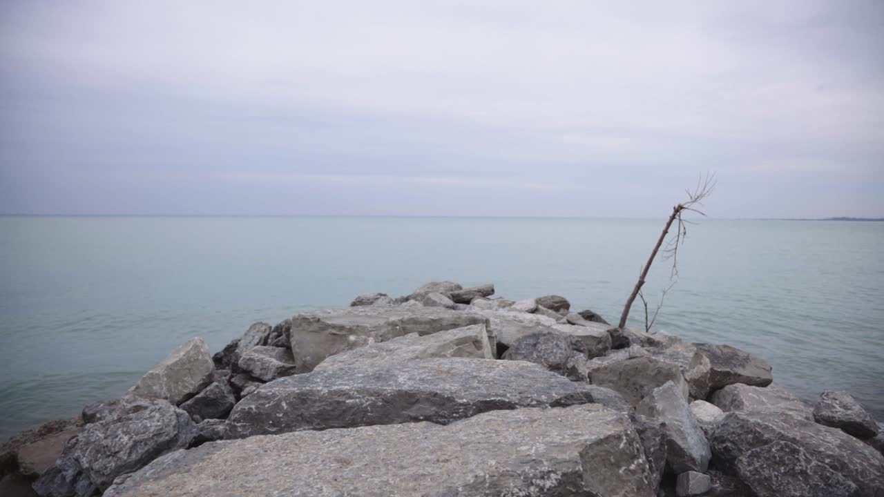 Sea Waves Breaking Gently On The Stony Beach In Canada - Wide Shot
