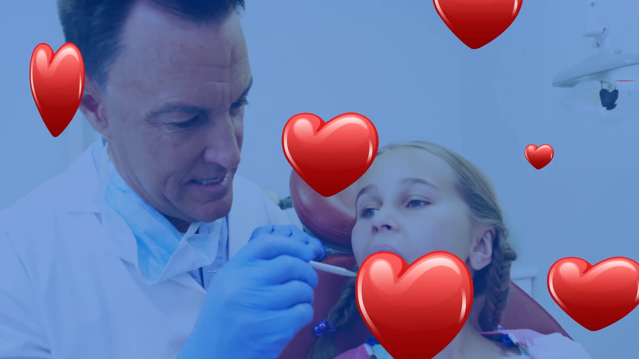 Animação de ícones de coração sobre um dentista caucasiano atendendo uma garota caucasiana