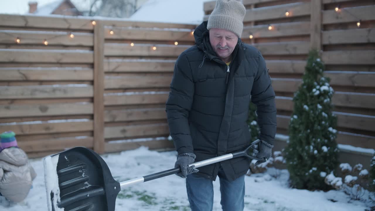 Grandfather and Granddaughter Having Fun in the Snow