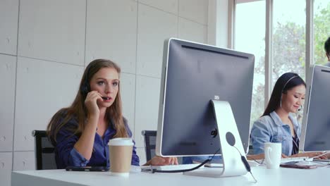 customer support agent or call center with headset talking to customer on phone.