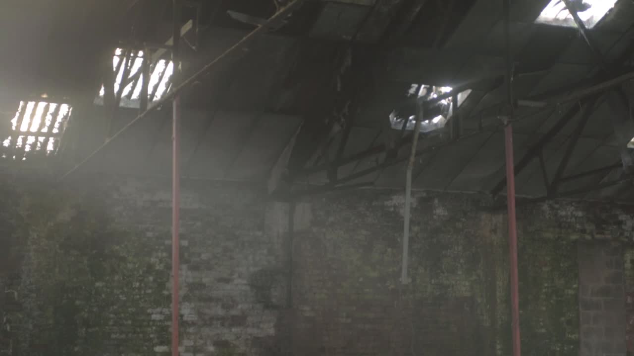 Light shines through rafters roof windows of derelict building