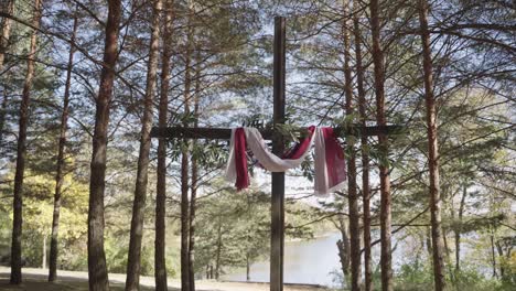 decorated jesus cross in an outdoor forest during the day