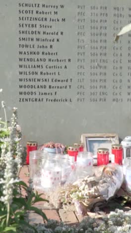 memorial for fallen soldiers with candles and names